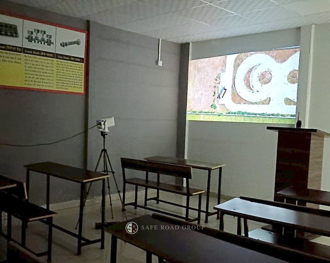 A classroom, the test track layout on the projector and a vehicle mechanism chart on the wall
