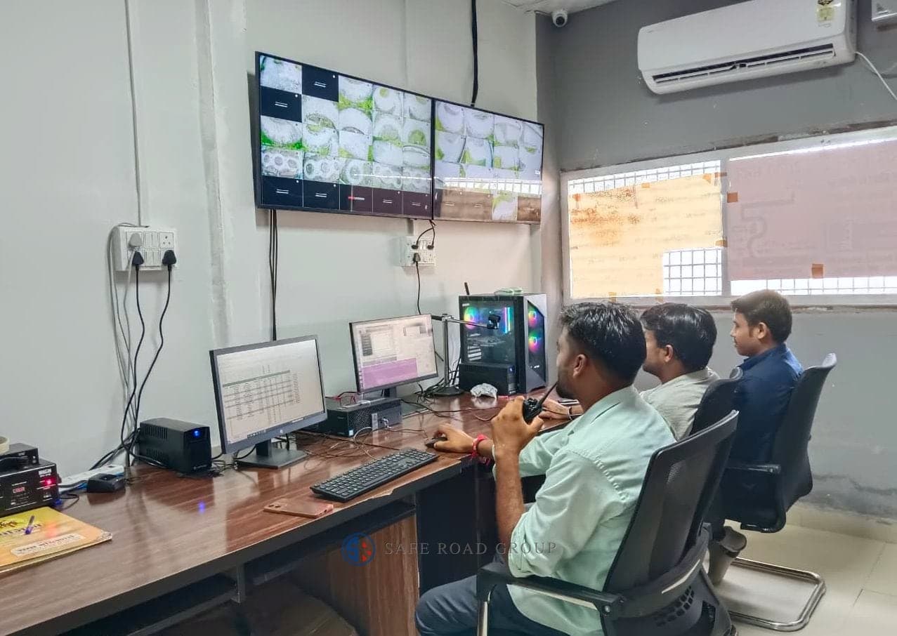 The track control room during a session — the camera wall covering the circuit, the run being scored on the monitors