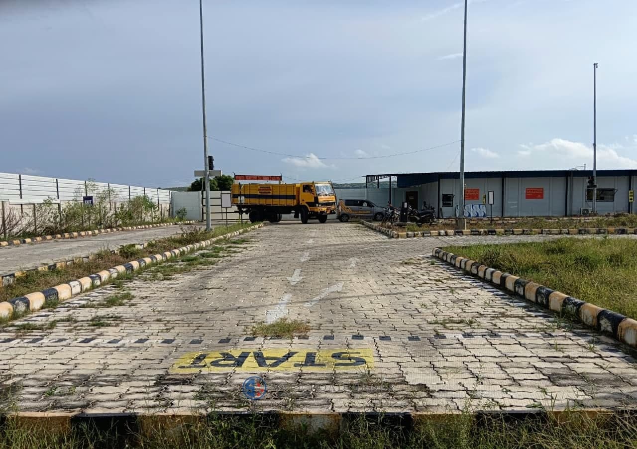 The start of the test lane, the START marking and the sensor studs laid across it, with a training truck waiting at the far end