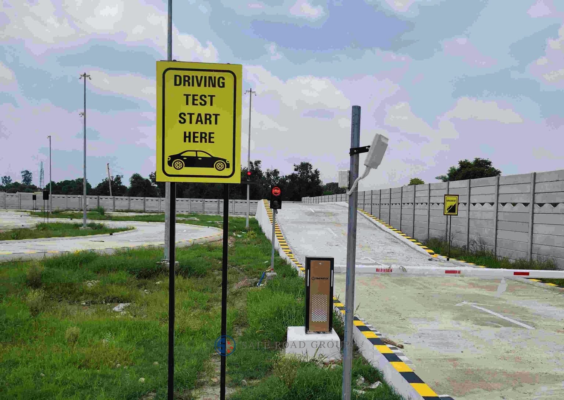 The start of the driving test lane, the boom barrier and the sensor post beside it